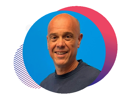 Man with short bald head smiling against a blue background with colorful circular graphic elements.