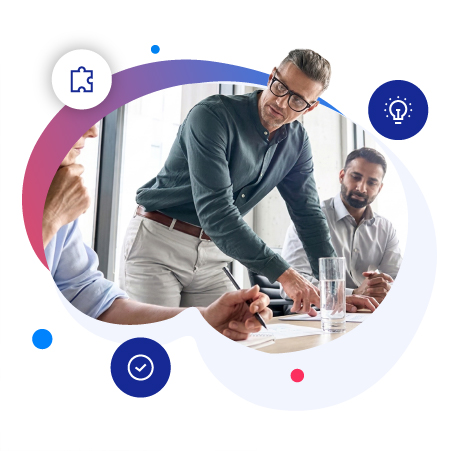 Business meeting with three individuals, one presenting ideas while others listen, with notes and glasses of water on the table.