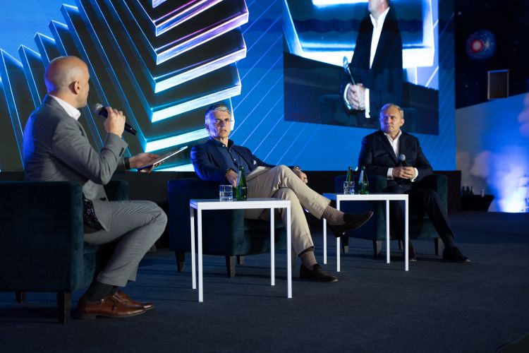 Panel debate with industry experts and Comarch CEO sitting in&nbsp;armchairs on&nbsp;the main stage at&nbsp;Comarch User Group 2026.